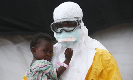 A health worker holds a child at the MSF treatment center in Paynesville, Liberia
