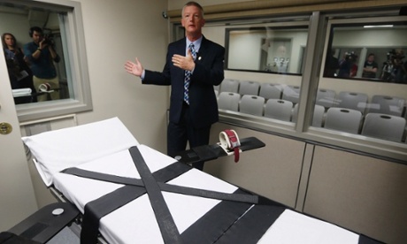Department of Corrections official Scott Crow talks behind the newly renovated death chamber at the Oklahoma State Penitentiary during a media tour of the facility in McAlester.