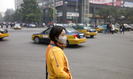 A woman wears a face mask on the street in Beijing amid heavy smog.