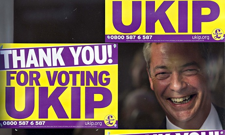 Ukip leader Nigel Farage looks through the party's office window in Clacton after winning byelection
