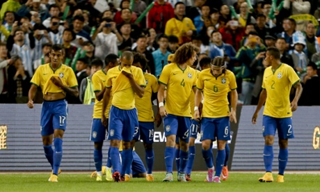 Diego Tardelli of Brazil celebrates with team mates after scoring his team's first goal.