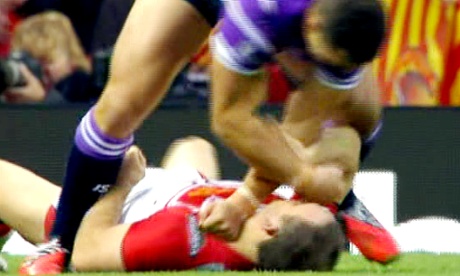 Wigan's Ben Flower punches Paul Wellens of St Helens as he lies on the floor in the Super League Grand Final.