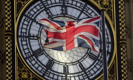 The union flag is seen flapping in the wind in front of Big Ben.