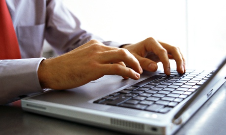 Man's hands on keyboard of laptop computer