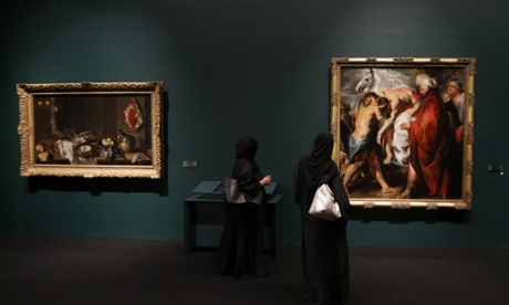 (FILES) - A file picture taken on April 21, 2013 shows Emirati visitors walking past paintings that are part of 130 artworks featured at the first large-scale presentation of the permanent collection of Abu Dhabi's planned Louvre Museum, at a venue on the Saddiyat Island where the museum will be built off the Emirati capital. Masterpieces of Leonardo da Vinci, Vincent Van Gogh, Claude Monet, Henri Matisse and Andy Warhol are among 300 works which will be on loan from 13 French museums for the opening of the The Louvre Abu Dhabi museum, the Emirates announced on October 11, 2014. AFP PHOTO/KARIM SAHIBKARIM SAHIB/AFP/Getty Images