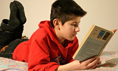 portrait of a young boy reading a book