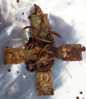 An early medieval cross, part of a hoard of Viking treasure which has been unearthed by metal-detecting enthusiast Derek McLennan in one of the most significant finds of its kind ever made in Scotland.