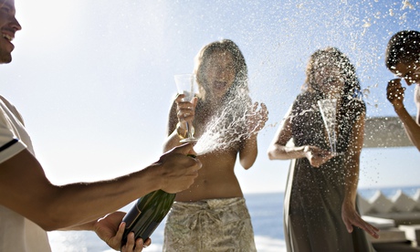 Man squirting friends with champagne