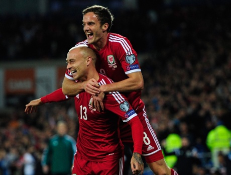 Wales deservedly go in front and David Cotterill celebrates the opener with Andy King.