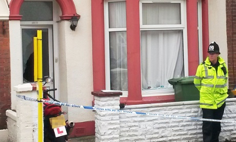 Police stand outside a house in Portsmouth, Hampshire, after six people were arrested on suspicion of terrorism offences following an operation by the South East Counter Terrorism Unit.