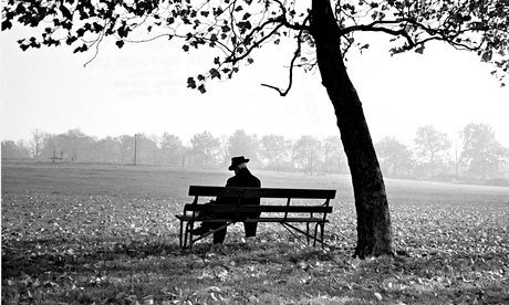 Man sitting on a bench under a tree