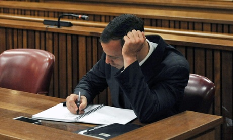 Oscar Pistorius takes notes on day three of sentencing procedures at the high court in Pretoria.