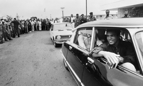 Muhammad Ali passes by a cheering crowd in Kinshasa, Zaire, on September 28, 1974 before his world heavyweight championship fight against champion George Foreman.