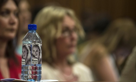 June Steenkamp watches proceedings beside a water bottle bearing stickers of her daughter Reeva Steenkamp.