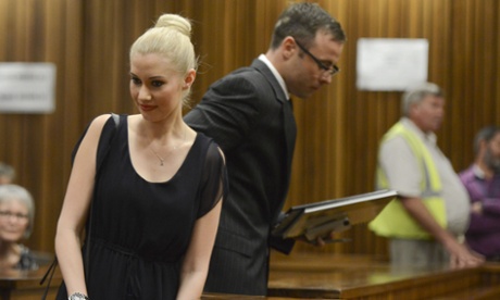 Oscar Pistorius makes his way past his ex-girlfriend Samantha Taylor as he arrives in the Pretoria high court for sentencing on Tuesday.