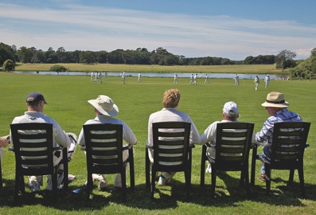 A cricket match in front of Holkham Hall