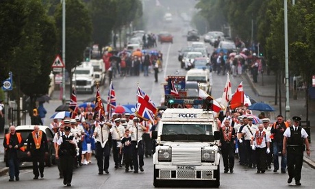 An armoured police vehicle escorts an Orange Order parade on Crumlin Road on 12 July commemorations