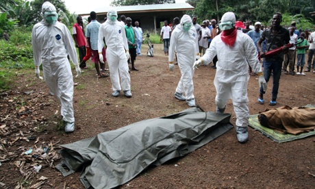 Liberian nurses prepare to carry the body of an Ebola victim for burial in the Banjor Community on the outskirts of Monrovia.