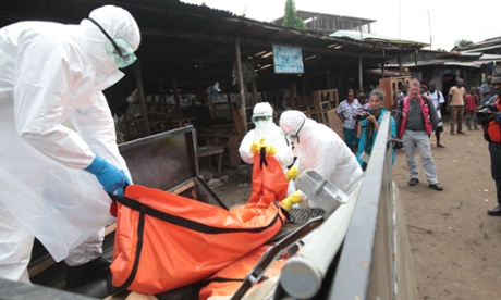 Health workers load a body infected with Ebola virus onto a pickup truck  in Monrovia, capital of Liberia.
