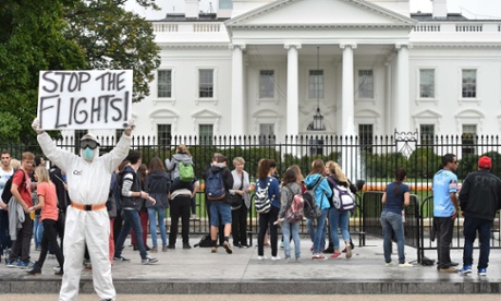 Jeff Hulbert from Annapolis, Maryland, dressed in a protective suit and mask holds a poster demanding for a halt of all flights from West Africa. ebola