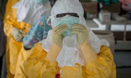 Health workers get ready before entering high risk area in Liberia.