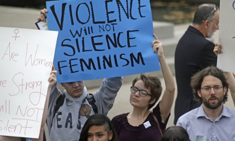 People protest on the campus of Utah state, Wednesday, Oct. 15, 2014, in Logan, Utah.