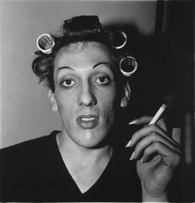 A young man in curlers at home on West 20th street, NYC, 1966, by Diane Arbus