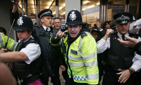 Beat officers: Police on crowd control at a property fair at Olympia, London, last week. Their numbers have been cut by 20% in recent years.