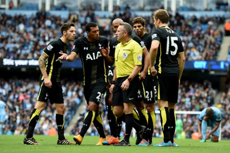 Spurs players protest to ref Jonathan Moss.