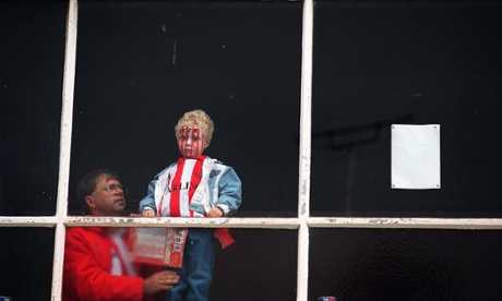 STOKE CITY FOOTBALL FANS LOOK OUT FROM THE MAIN STAND AT THE VICTORIA GROUND FOR THE LAST TIME