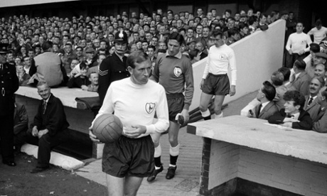 Tottenham Hotspur captain Danny Blanchflower leads his team onto the field at the Victoria Ground in Stoke, prior to their First Division match against Stoke City, circa 1963.