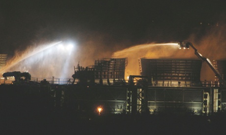 Fire crews spray water at the scene of a fire at Didcot B power station in Oxfordshire.