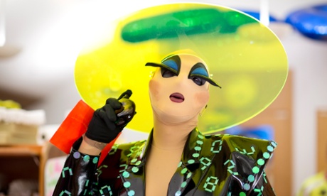 Miss Melonie Peel (Lee Benjamin) sprays perfume backstage