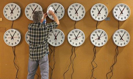 Man cleans clock faces