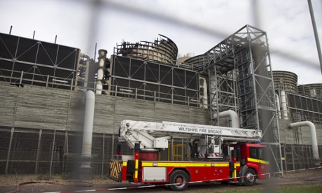 A fire engine is parked in front of a fire damaged part of the Didcot B power station