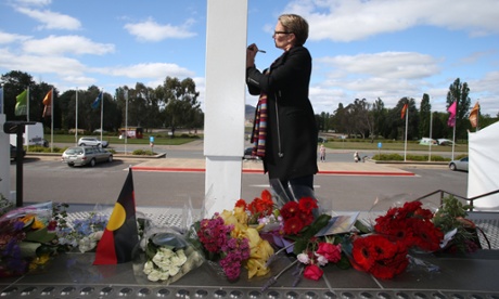 Claire Yeo from Bowral NSW writes on a card to add to a growing memorial on the steps of Old Parliament House in Canberra this afternoon. Claire's parents were inspired by Prime Minister Gough Whitlam and were according to Claire, lifelong 