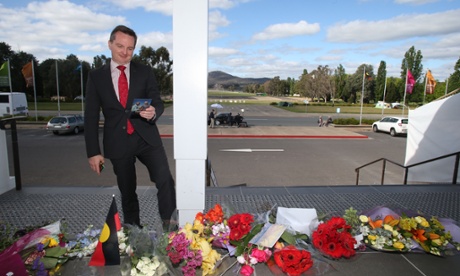 Shadow Treasurer Chris Bowen reads cards and tributes left at a growing memorial on the steps of Old Parliament House in Canberra this afternoon, Tuesday 21st October 2014.