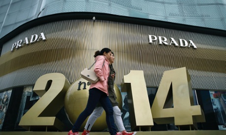 Chinese women walk past a luxury fashion boutique at a shopping mall in Beijing.