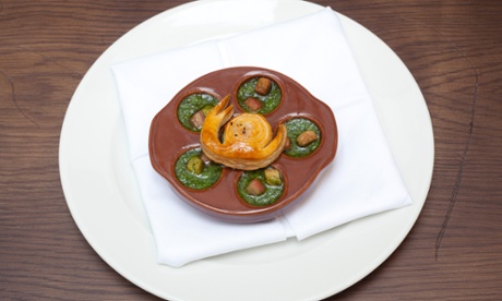 Round plate with five snails in green sauce at Brasserie Gustave.