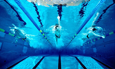 Underwater photograph of a boys high school swim team practicing in an Olympic size swimming pool.