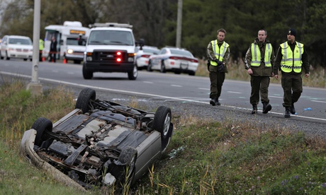 Quebec officer investigates an overturned vehicle in Saint-Jean-sur-Richelieu