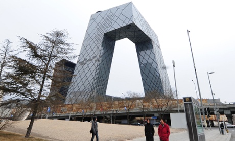 Pedestrians are dwarfed by the CCTV Headquarters in Beijing on February 28, 2010. The futuristic 54-storey building standing 234 metres, or 768 feet tall, for the state-run China Central Television was designed by European architects Rem Koolhaas and Ole Scheeren. AFP PHOTO/Frederic J. BROWN (Photo credit should read FREDERIC J. BROWN/AFP/Getty Images)CITYILLUSTRATIONARCHITECTURE MONUMENT CHINAARCHITECTUREHORIZONTALTOURISTTELEVISION PREMISESSTREETPASSER-BY