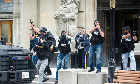 mergency responders escort VIPs out of a building on Sparks Street near the Post Office after a gunman shot a soldier as he was standing guard at the National War Memorial in Ottawa, Canada