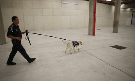 AFP officer Cedric Perrett with Gomer patrolling the car park of Parliament House in Canberra this morning, Thursday 23rd October 2014