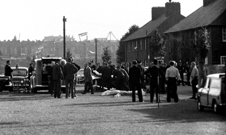 The bodies of the police officers are removed from the scene where they were shot dead in Shepherds Bush, west London.