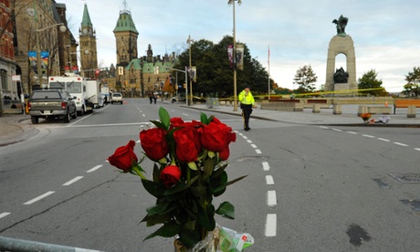 Flowers adorn a barricade around the war memorial in Ottawa.