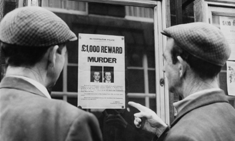 Two men read a 'wanted' poster for Harry Roberts in 1966