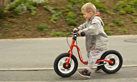 Bike blog : Boy riding a balance bicycle on the sidewalk