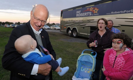 Republican US Senator Pat Roberts cradles a baby after speaking at a Conservative Revival in Gardner, Kansas 