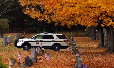 A Pennsylvania state police trooper patrols the cemetery in Swiftwater during the ongoing search for suspected killer Eric Frein. 